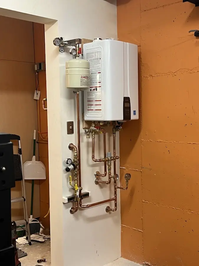 Plumbing technician inspecting water heater connections in North River Shores